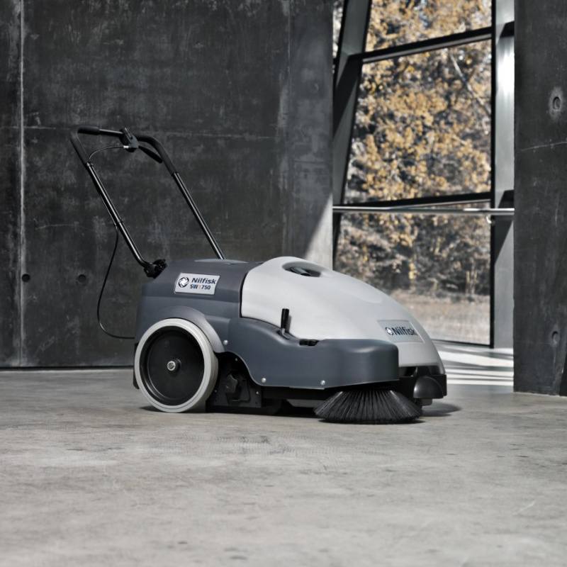 Nilfisk SW750 Mid Sized Walk Behind Sweeper On Concrete