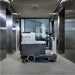 Nilfisk SC2000 Ride On Scrubber Dryer Next to Lifts