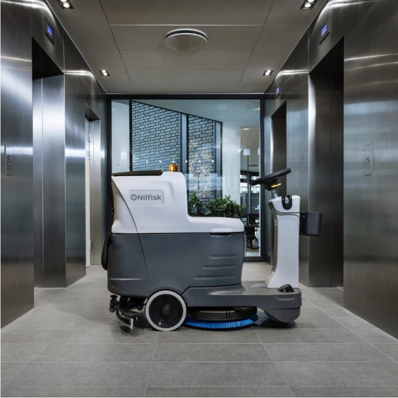Nilfisk SC2000 Ride On Scrubber Dryer Next to Lifts