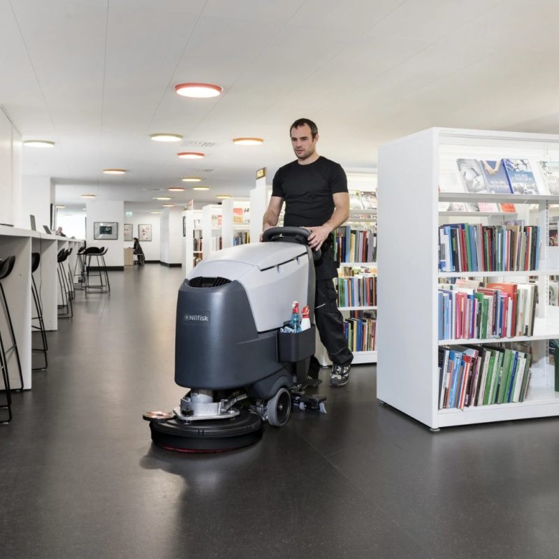 Nilfisk SC500 Mid Sized Walk Behind Scrubber Dryer Action In Library