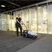 Nilfisk SW750 Mid Sized Walk Behind Sweeper Used By Woman